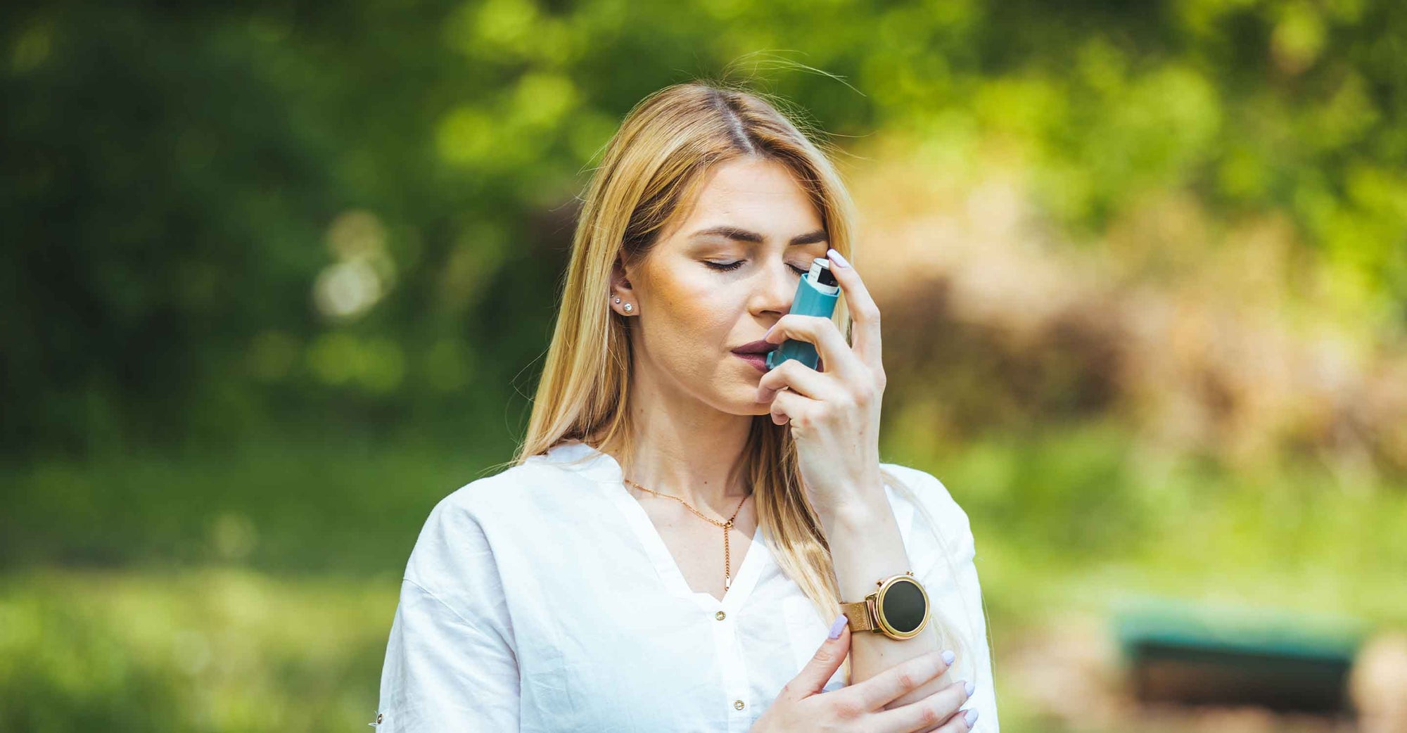 Woman with inhaler outdoors